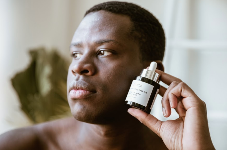 man holding face oil
