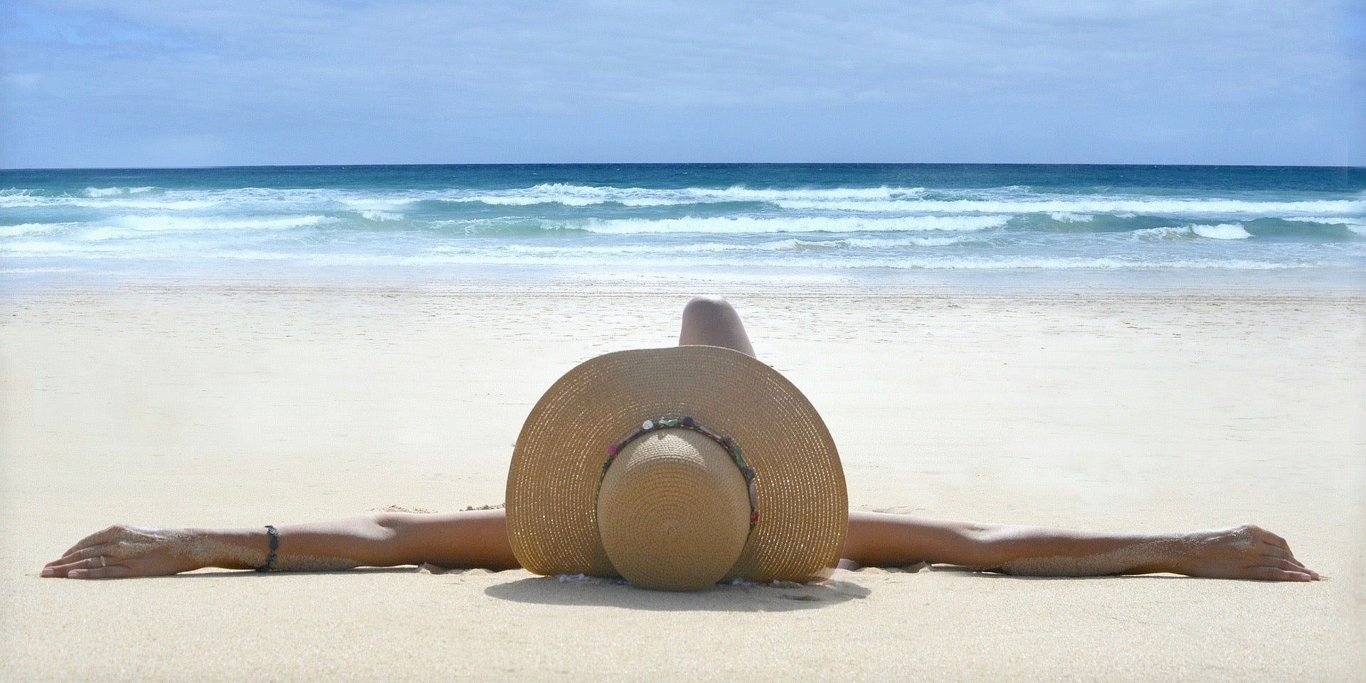 Image of woman lying on the beach in the sun